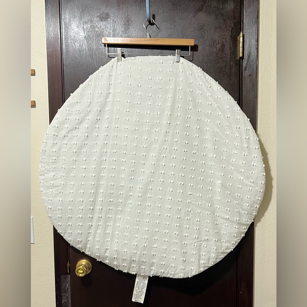 Big white round textured and padded baby photo mat